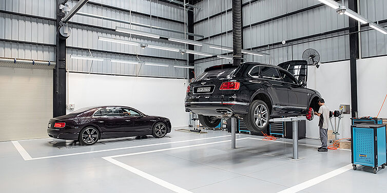 Bentley Bentayga SUV and Bentley Continental GT coupe undergoing servicing at authorised Bentley Ho Chi Minh service workshop.